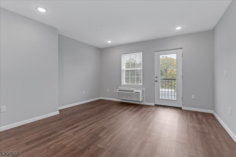 224 Broad Street Bloomfield, NJ 07003 - Photo 45 of 45 an empty room with wooden floor and windows