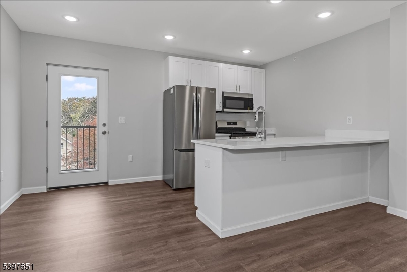 224 Broad Street Bloomfield, NJ 07003 - Photo 7 of 45 a kitchen with stainless steel appliances a microwave a sink and a refrigerator