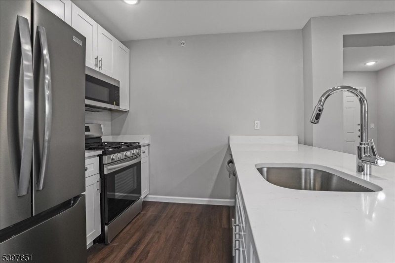 224 Broad Street Bloomfield, NJ 07003 - Photo 10 of 45 a kitchen with a sink cabinets and stainless steel appliances