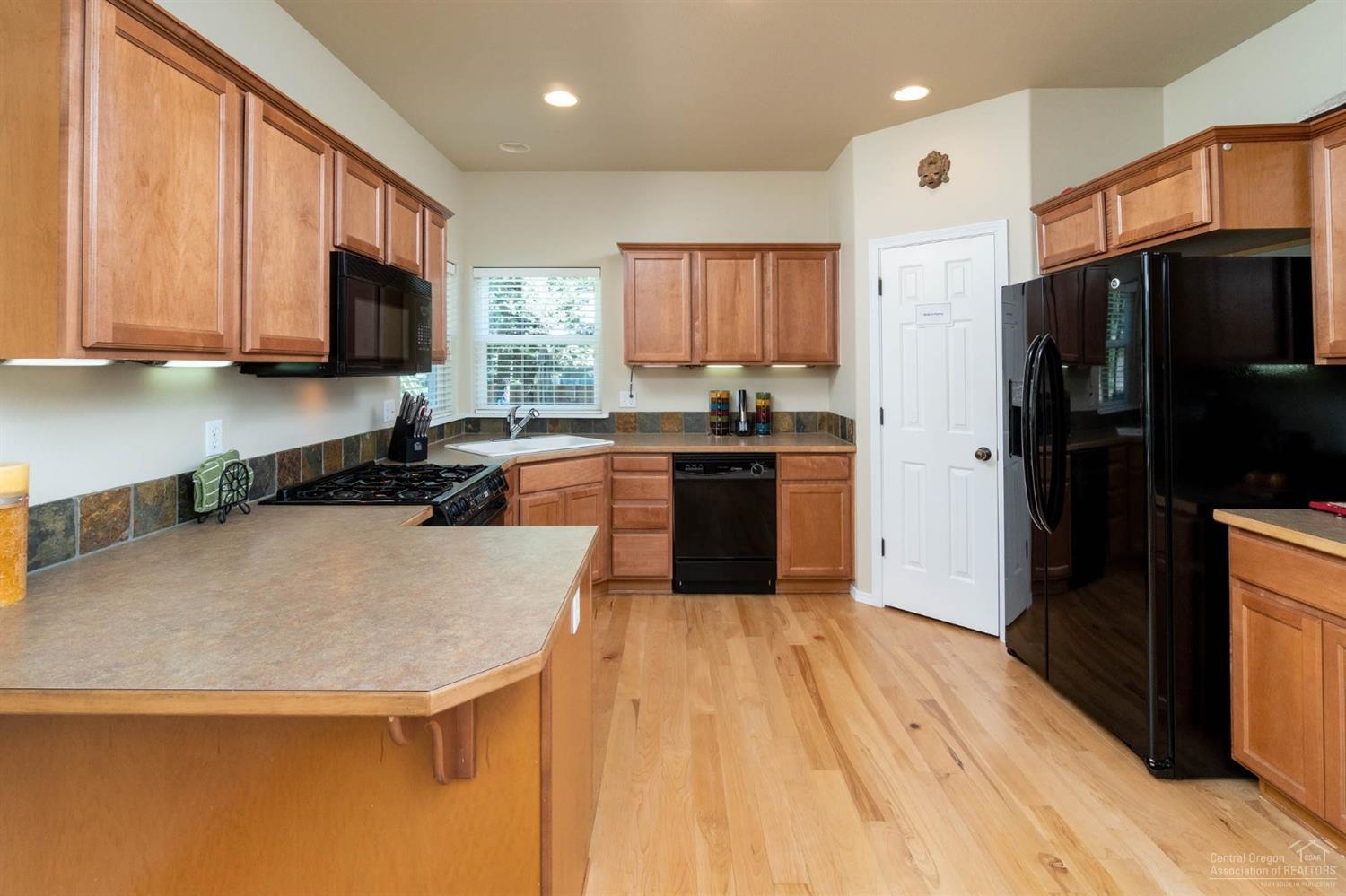 19582 Brookside Way Bend, OR 97702 - Photo 5 of 10 Open sunlit kitchen with walk in pantry
