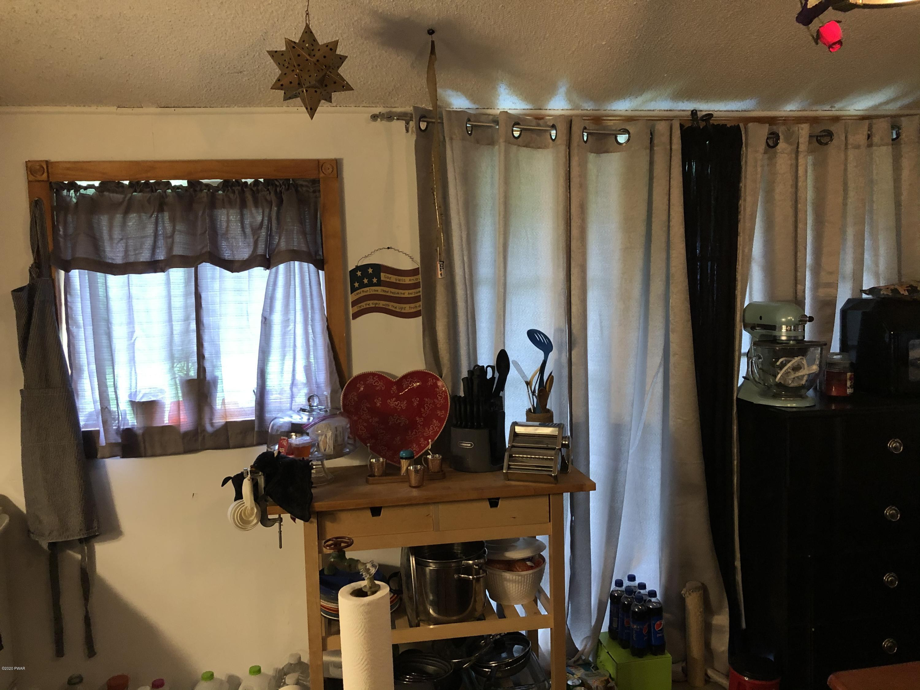 177 Skyview Road Dingmans Ferry, PA 18328 - Photo 8 of 18 a room with a table and a mirror