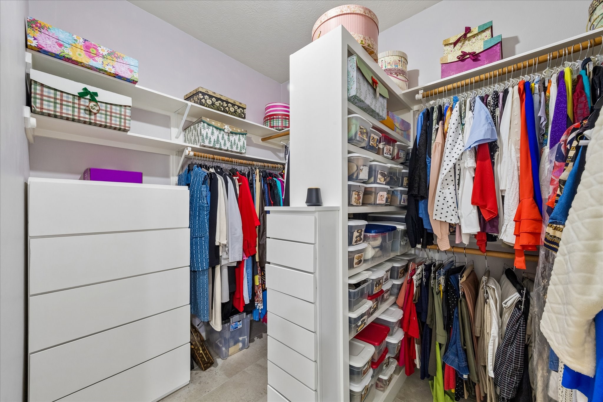 12423 Rutgers Park Court Houston, TX 77058 - Photo 22 of 29 a view of walk in closet with clothes and shoes