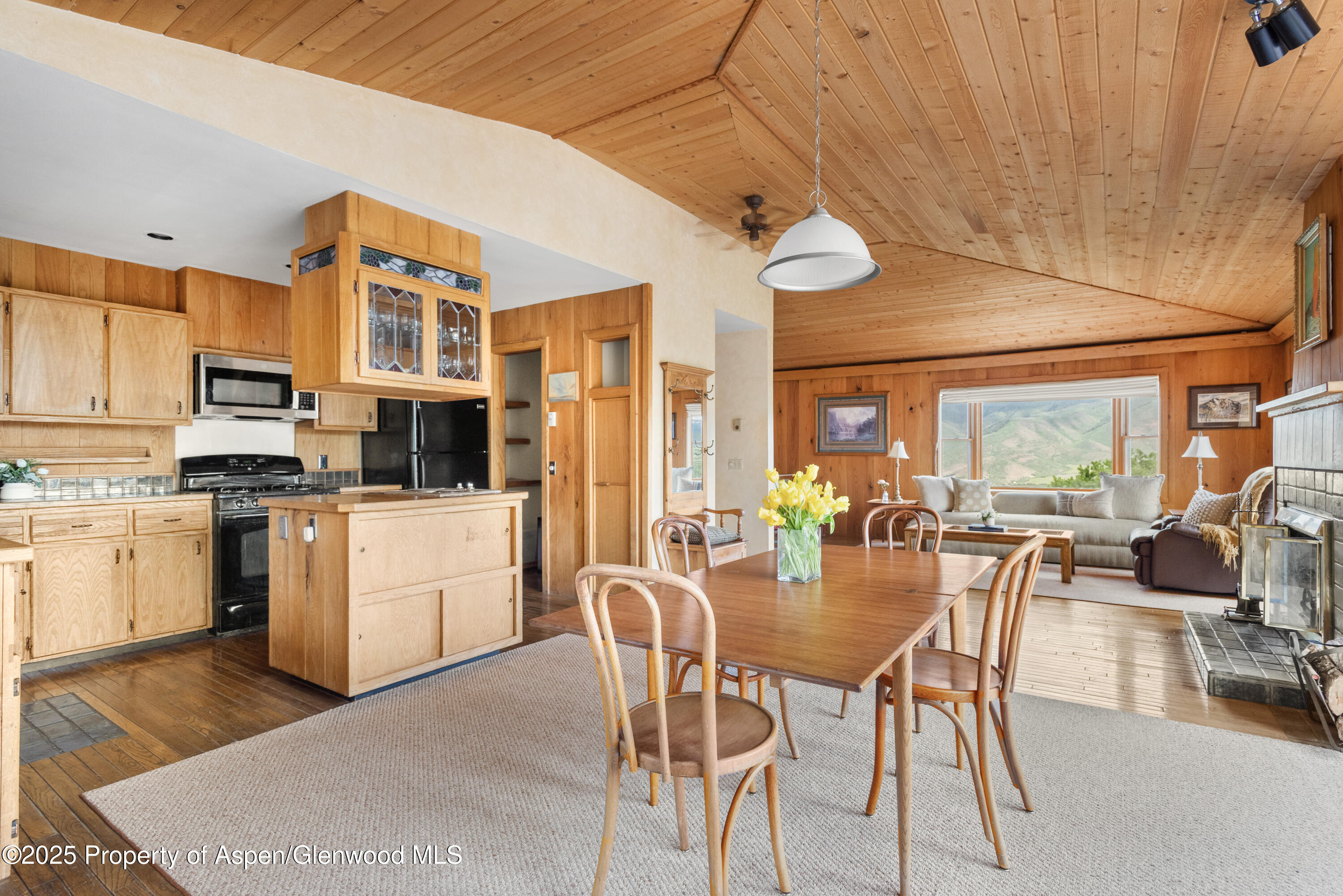a dining room with stainless steel appliances kitchen island granite countertop furniture and a view of kitchen