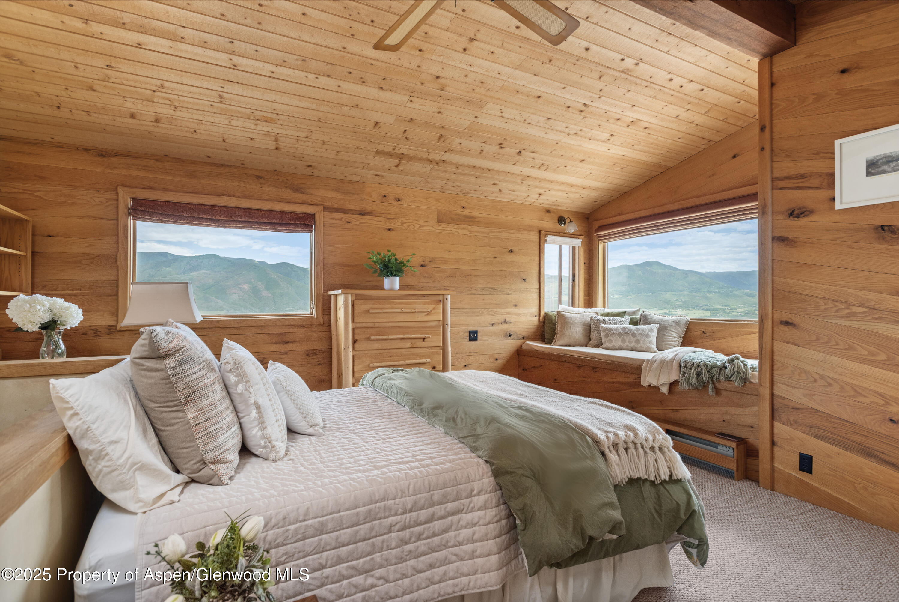 2020 Juniper Hill Road Aspen, CO 81611 - Photo 3 of 11 a bedroom with a bed and large windows