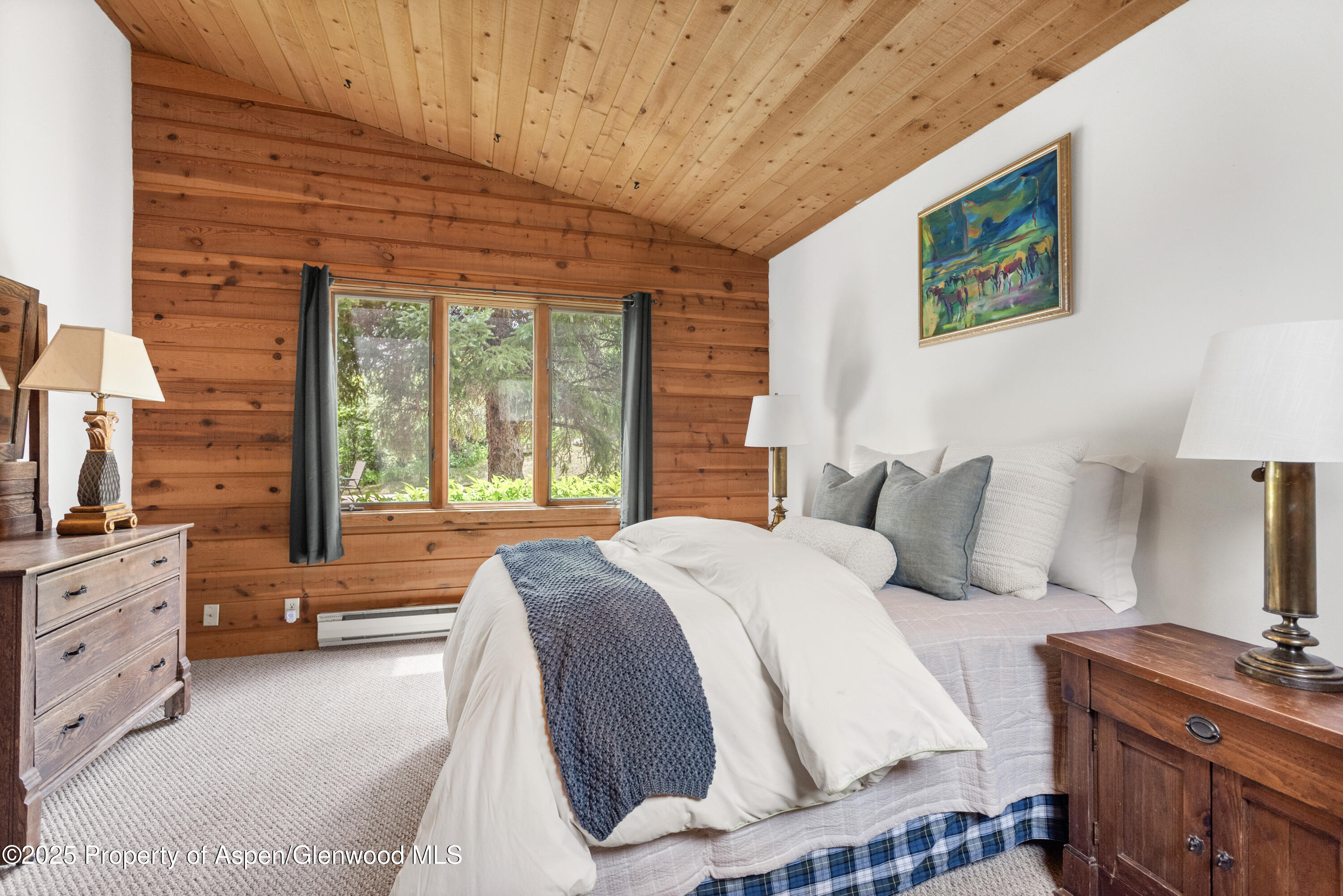 2020 Juniper Hill Road Aspen, CO 81611 - Photo 7 of 11 a bedroom with a bed and a dresser next to a window