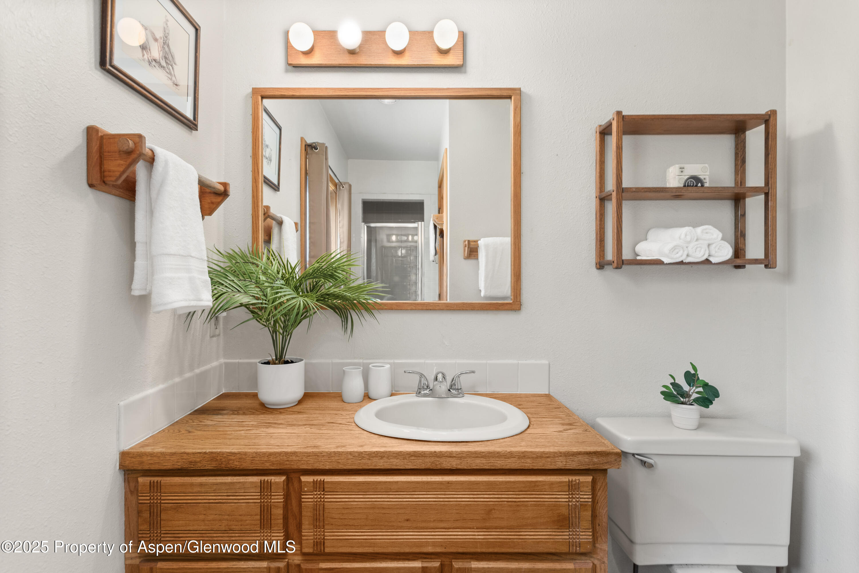 2020 Juniper Hill Road Aspen, CO 81611 - Photo 8 of 11 a bathroom with a granite countertop sink and a mirror