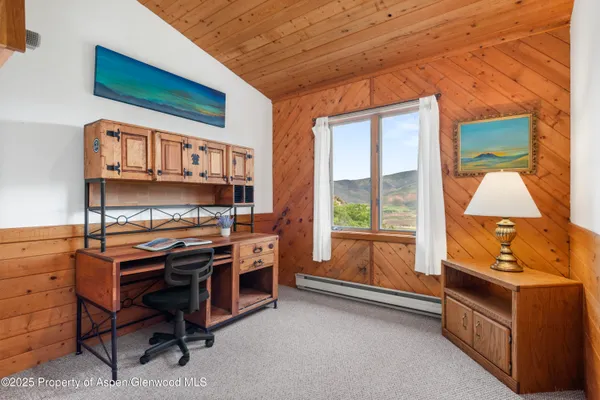 a view of workspace with furniture and window