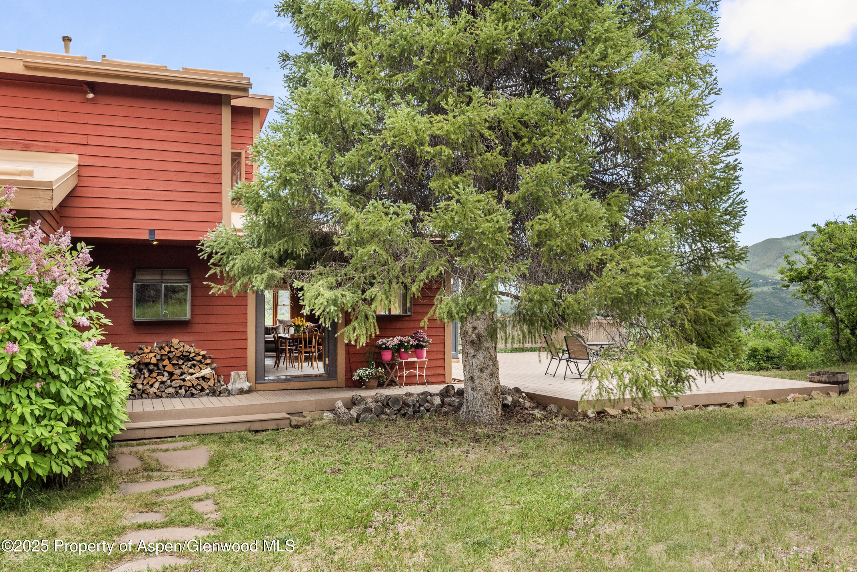 2020 Juniper Hill Road Aspen, CO 81611 - Photo 10 of 11 a view of a house with a yard and sitting area