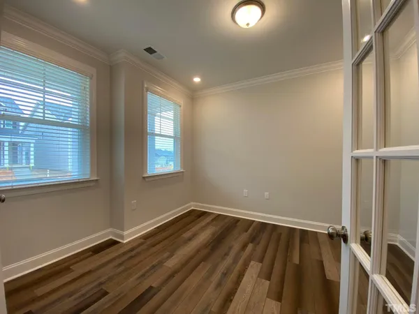 a view of a room with wooden floor and window