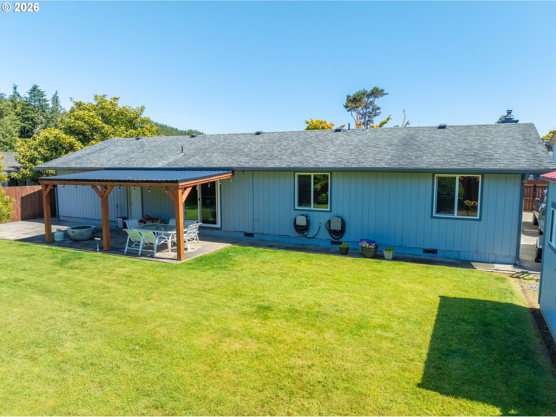412 Camellia Court Reedsport, OR 97467 - Photo 47 of 48 a view of a house with swimming pool and a yard