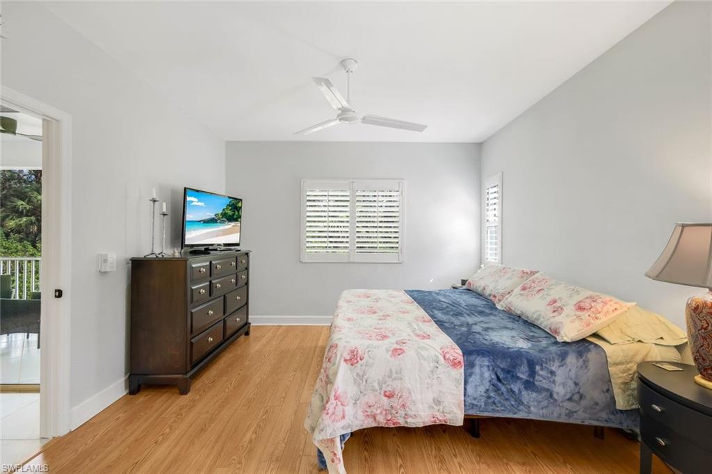 650 Luisa Lane, Unit 4 Naples, FL 34104 - Photo 11 of 19 a bedroom with a bed and a flat screen tv