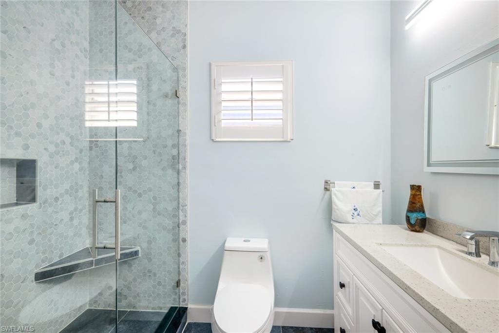 650 Luisa Lane, Unit 4 Naples, FL 34104 - Photo 16 of 19 a bathroom with a sink toilet and shower