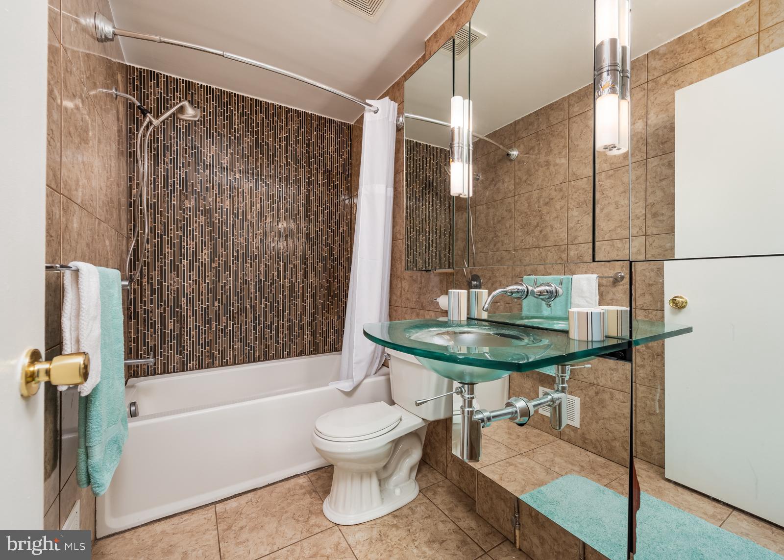 10544 East Wind Way Columbia, MD 21044 - Photo 13 of 42 a bathroom with a sink a toilet and shower