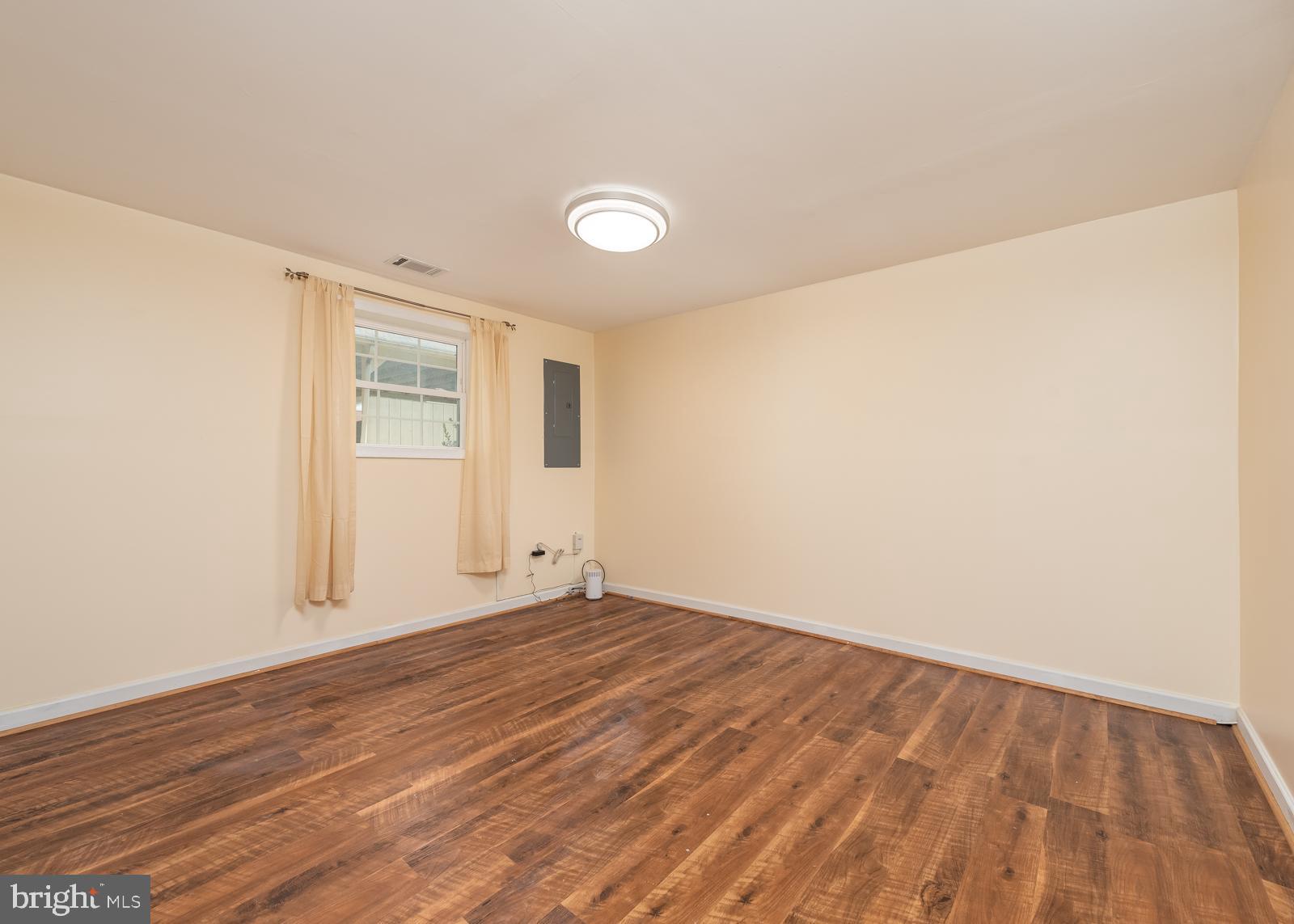 10544 East Wind Way Columbia, MD 21044 - Photo 20 of 42 a view of an empty room with wooden floor and a window