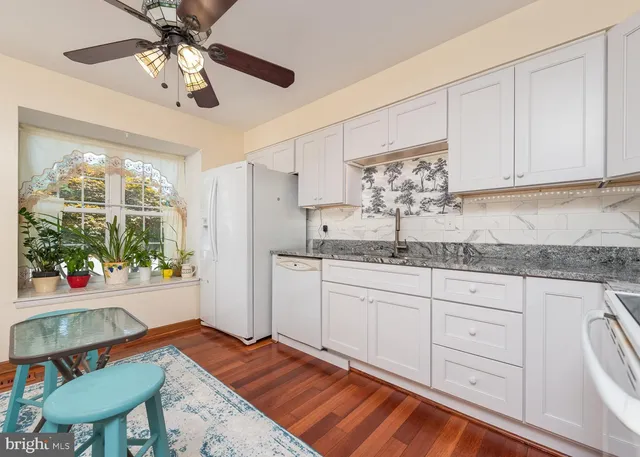 a kitchen with stainless steel appliances granite countertop a sink and cabinets