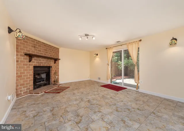 a view of an empty room with a fireplace