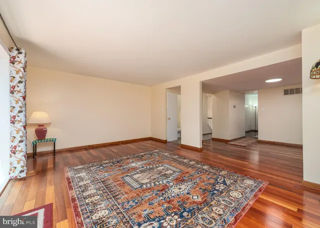 a view of a room with wooden floor and furniture