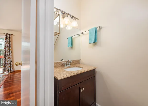a bathroom with a sink vanity and a mirror