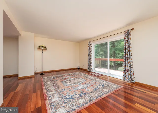 a view of a room with wooden floor and window