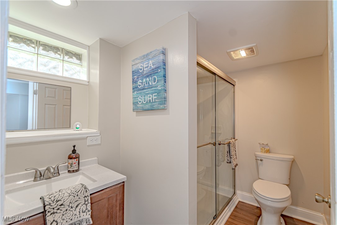 360 Baldwin Road Akron, OH 44312 - Photo 19 of 22 Bathroom featuring vanity, a stall shower, and wood finished floors