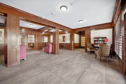 a view of a hall way with furniture