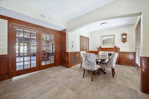 a dining room with furniture and window