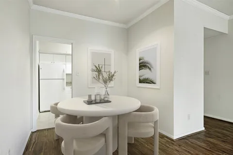 a dining room with furniture and wooden floor