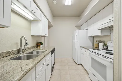a kitchen with a sink stove and refrigerator