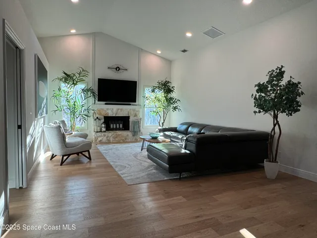 a kitchen with stainless steel appliances a sink a stove a refrigerator cabinets and a dining table