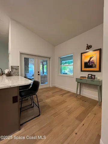 a kitchen with stainless steel appliances kitchen island granite countertop a refrigerator a stove top oven and a sink