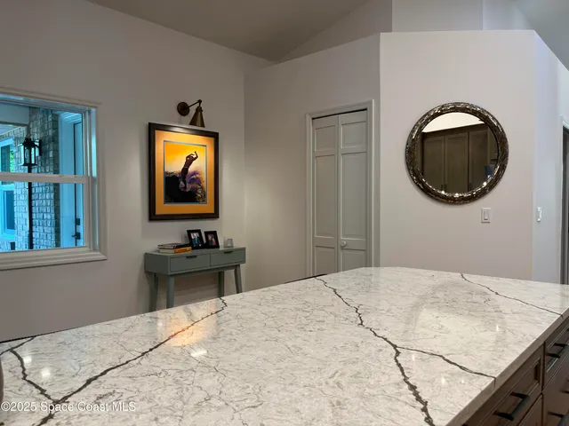 a kitchen with a sink cabinets and wooden floor