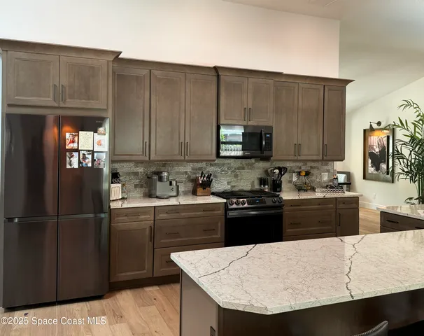 a kitchen with sink a microwave and cabinets