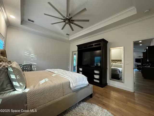 a bedroom with a bed and a night stand