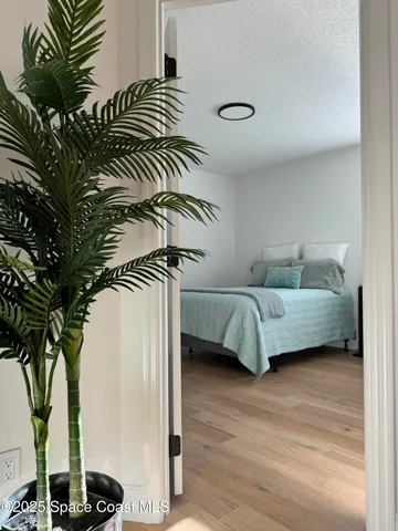 a spacious bathroom with a mirror a sink and a shower
