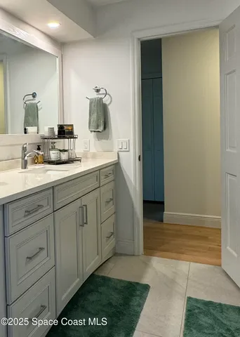 a backyard of a house with wooden stairs and furniture