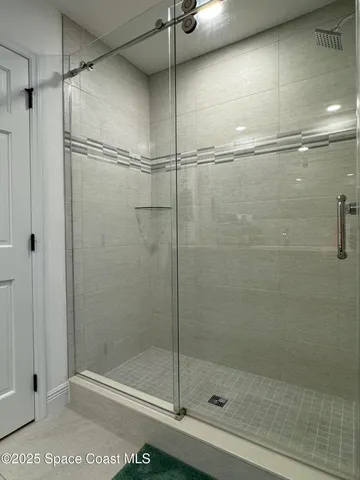 a view of a wooden floor with a swimming pool and sitting area