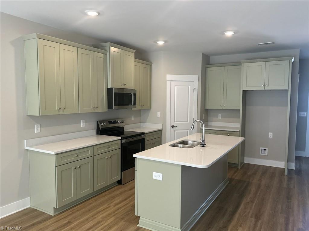7329 Dew Sharpe Road Gibsonville, NC 27249 - Photo 3 of 15 new green cabinets with white quartz counters