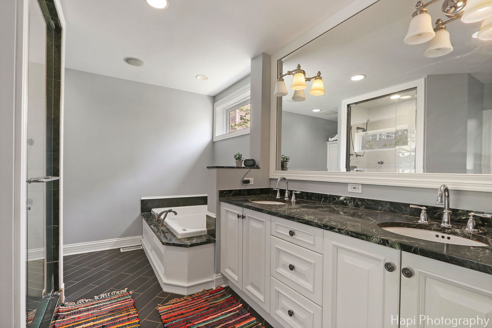 1340 North Sutton Place Chicago, IL 60610 - Photo 16 of 40 a bathroom with a granite countertop sink and a mirror