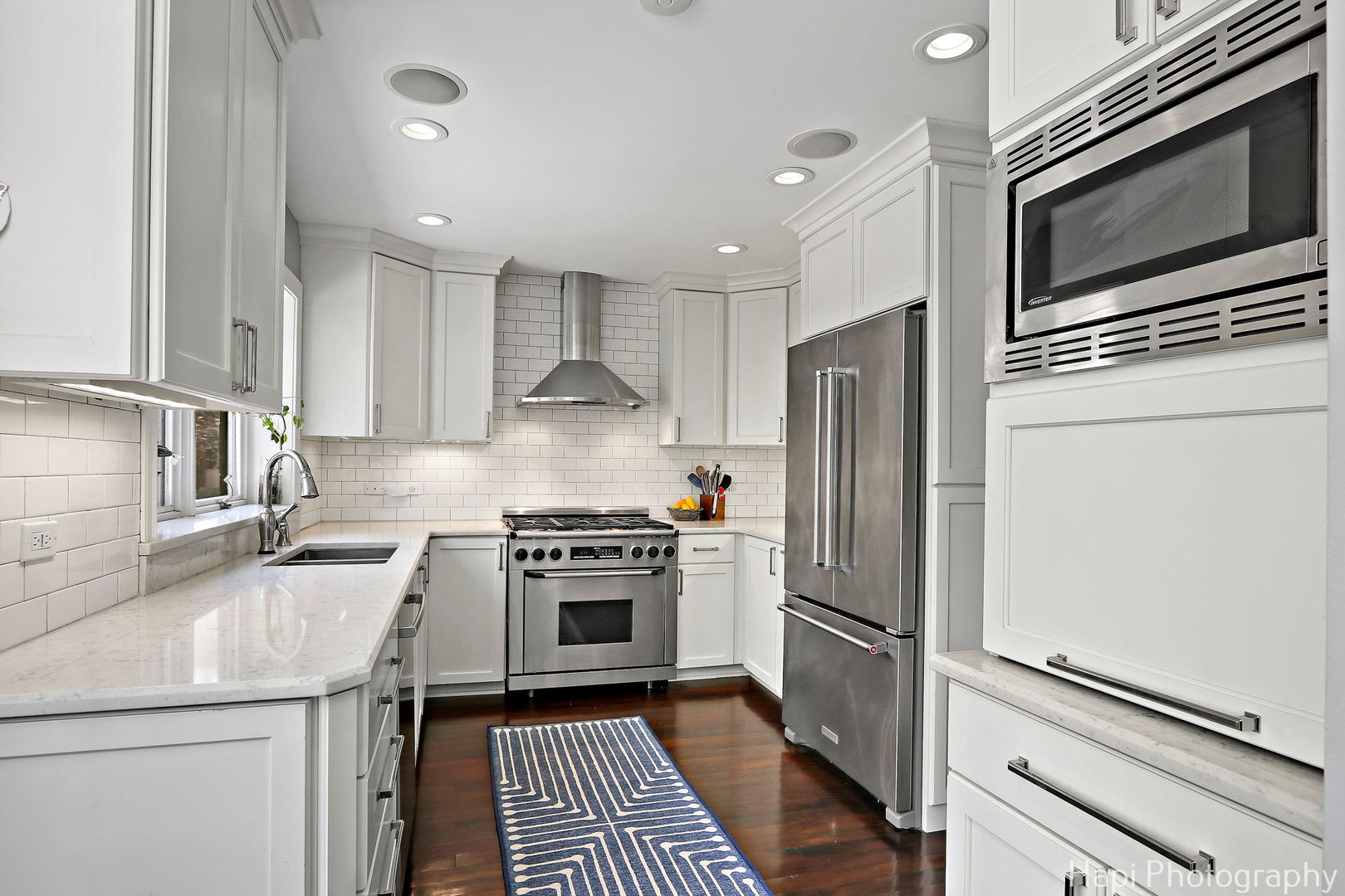1340 North Sutton Place Chicago, IL 60610 - Photo 8 of 40 a kitchen with a sink stove and refrigerator