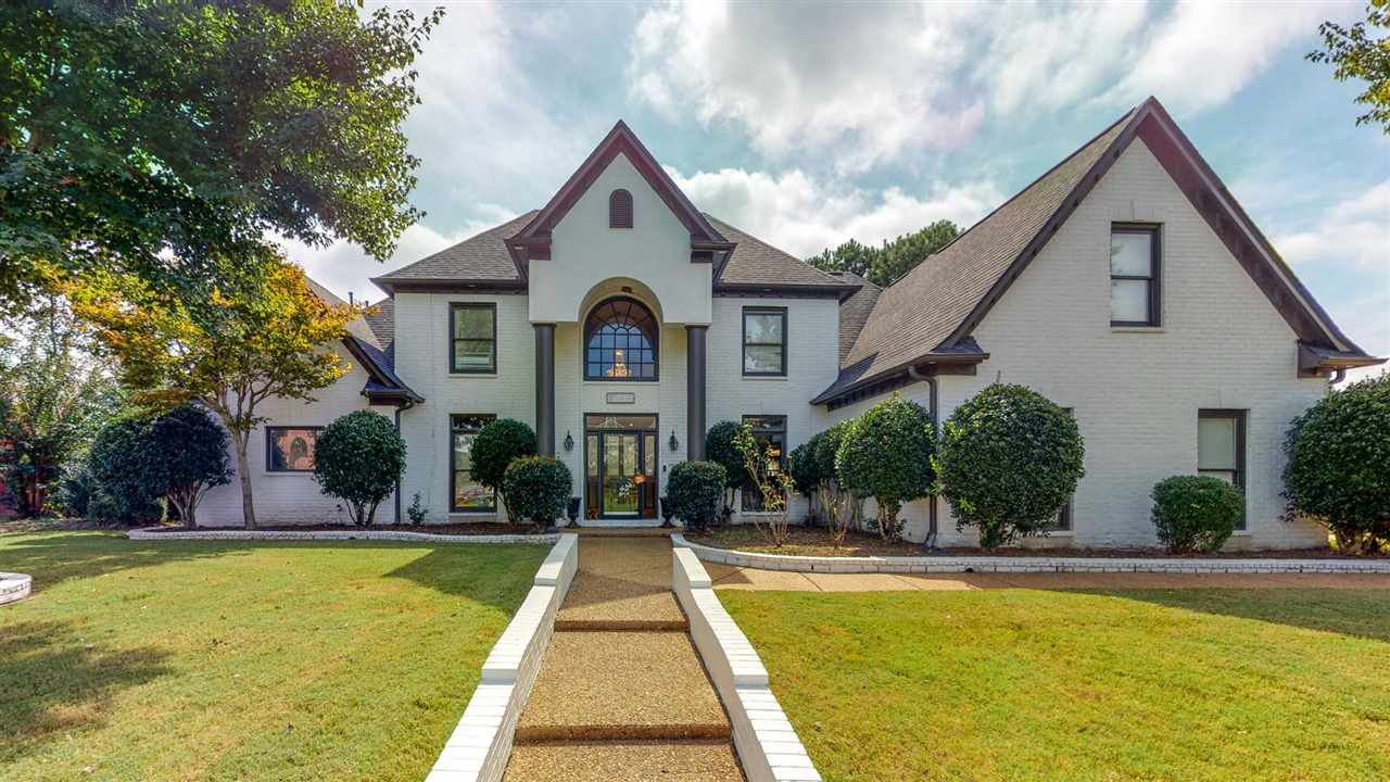 a front view of house with yard and green space