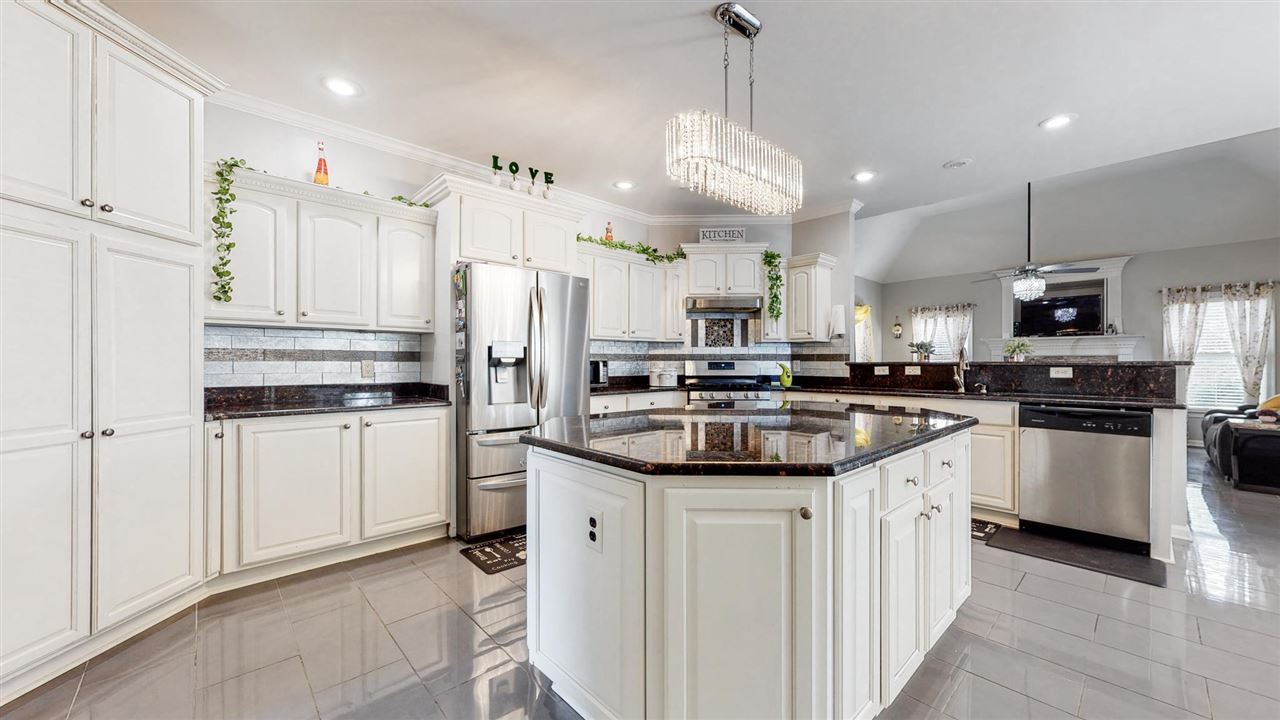419 Military Road Collierville, TN 38017 - Photo 16 of 25 a kitchen with stainless steel appliances kitchen island granite countertop a sink and cabinets