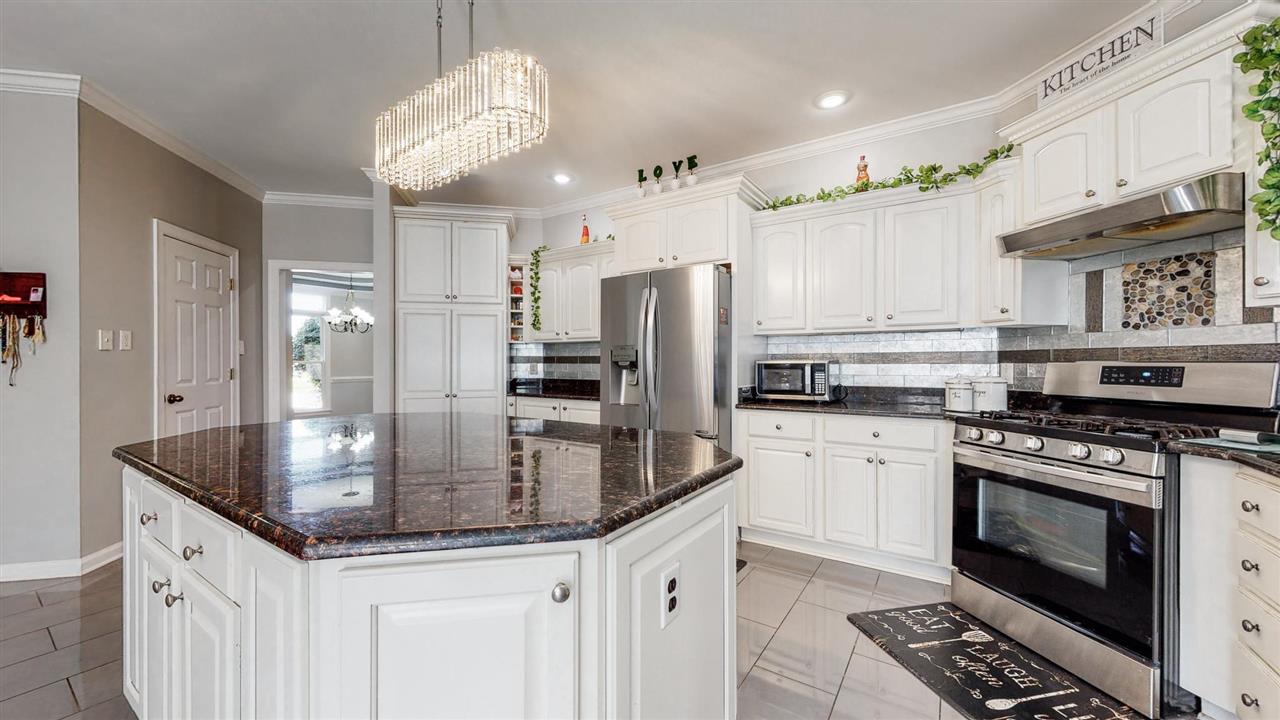 419 Military Road Collierville, TN 38017 - Photo 17 of 25 a kitchen with stainless steel appliances granite countertop a stove a sink and a refrigerator
