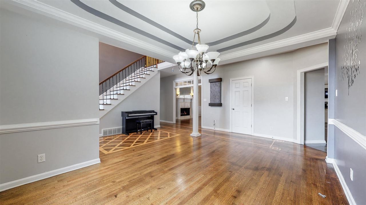 419 Military Road Collierville, TN 38017 - Photo 5 of 25 a view of a livingroom with a fireplace wooden floor and chandelier