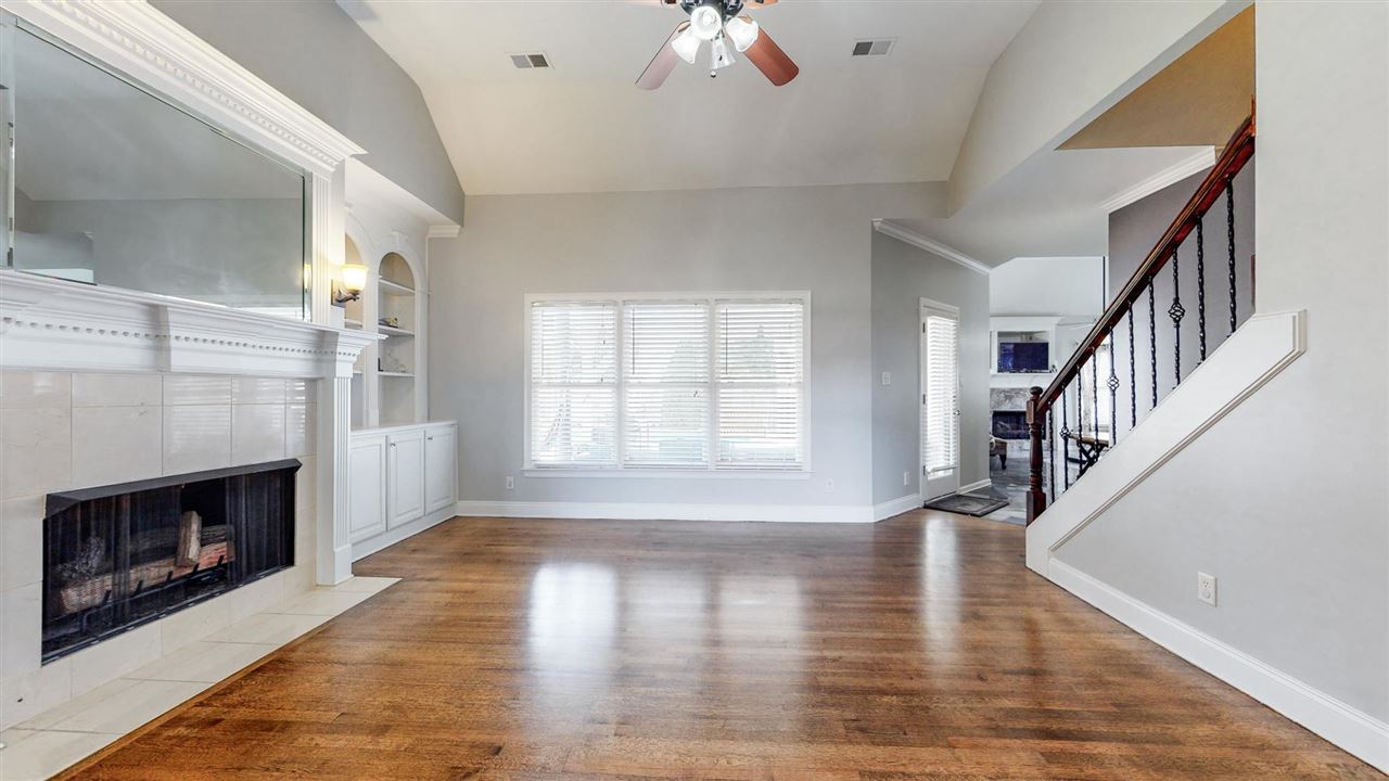 419 Military Road Collierville, TN 38017 - Photo 6 of 25 a view of an empty room with wooden floor fireplace and a window