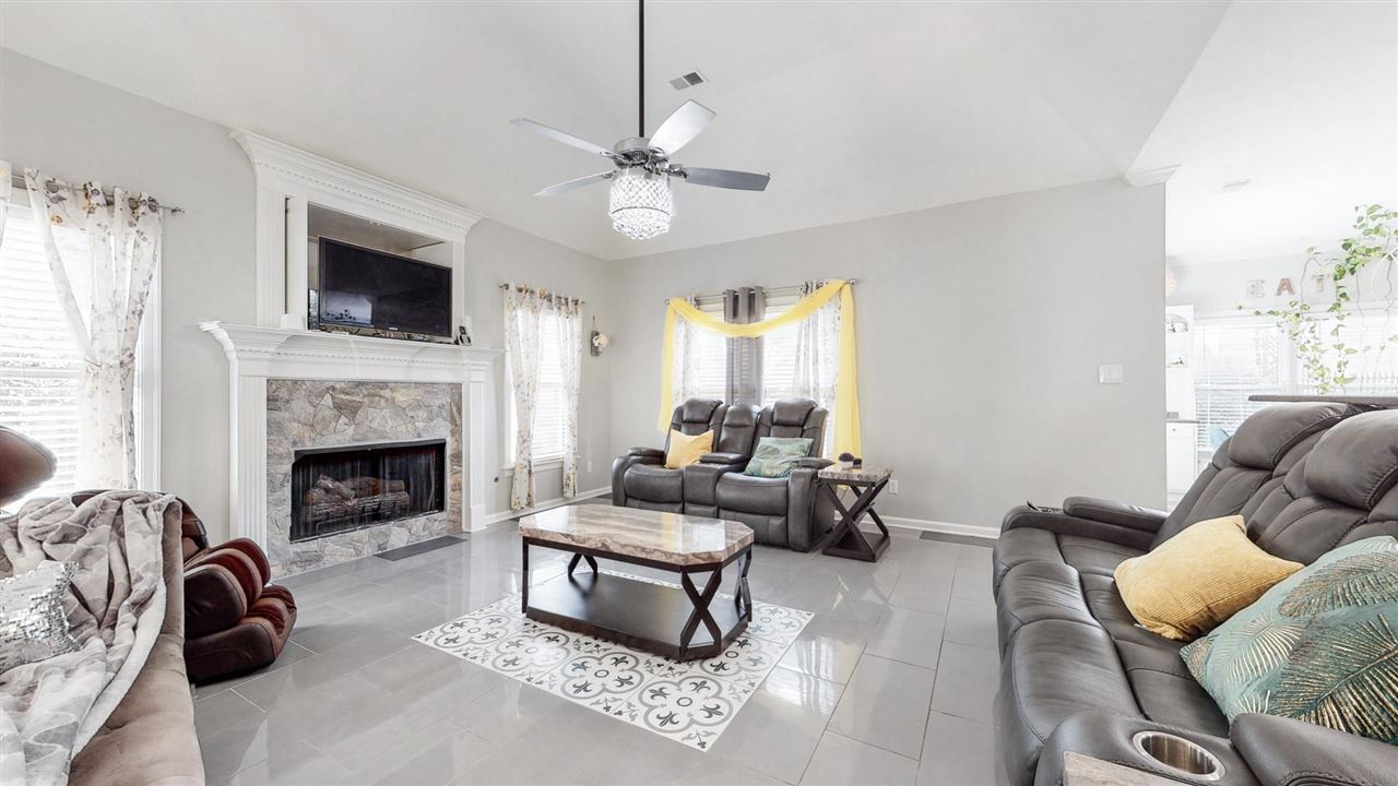 419 Military Road Collierville, TN 38017 - Photo 10 of 25 a living room with furniture a flat screen tv and a fireplace