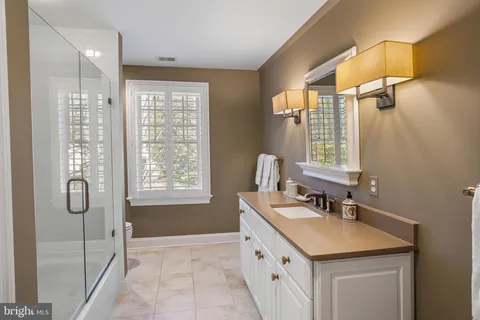 a bathroom with a sink double vanity and a shower