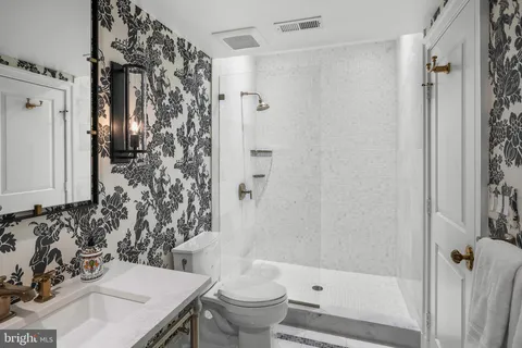 a bathroom with a sink toilet and shower