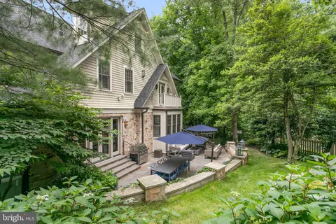 a view of backyard of house with seating space