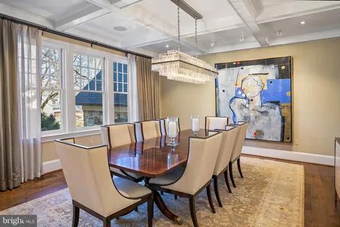 a view of a dining room with furniture large windows and wooden floor
