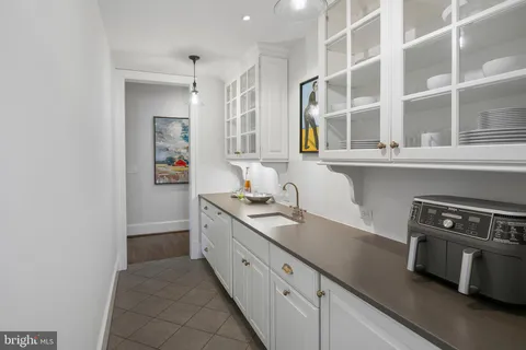 a kitchen with stainless steel appliances granite countertop a sink and a stove